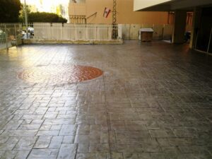 Concrete courtyard with red circular pattern