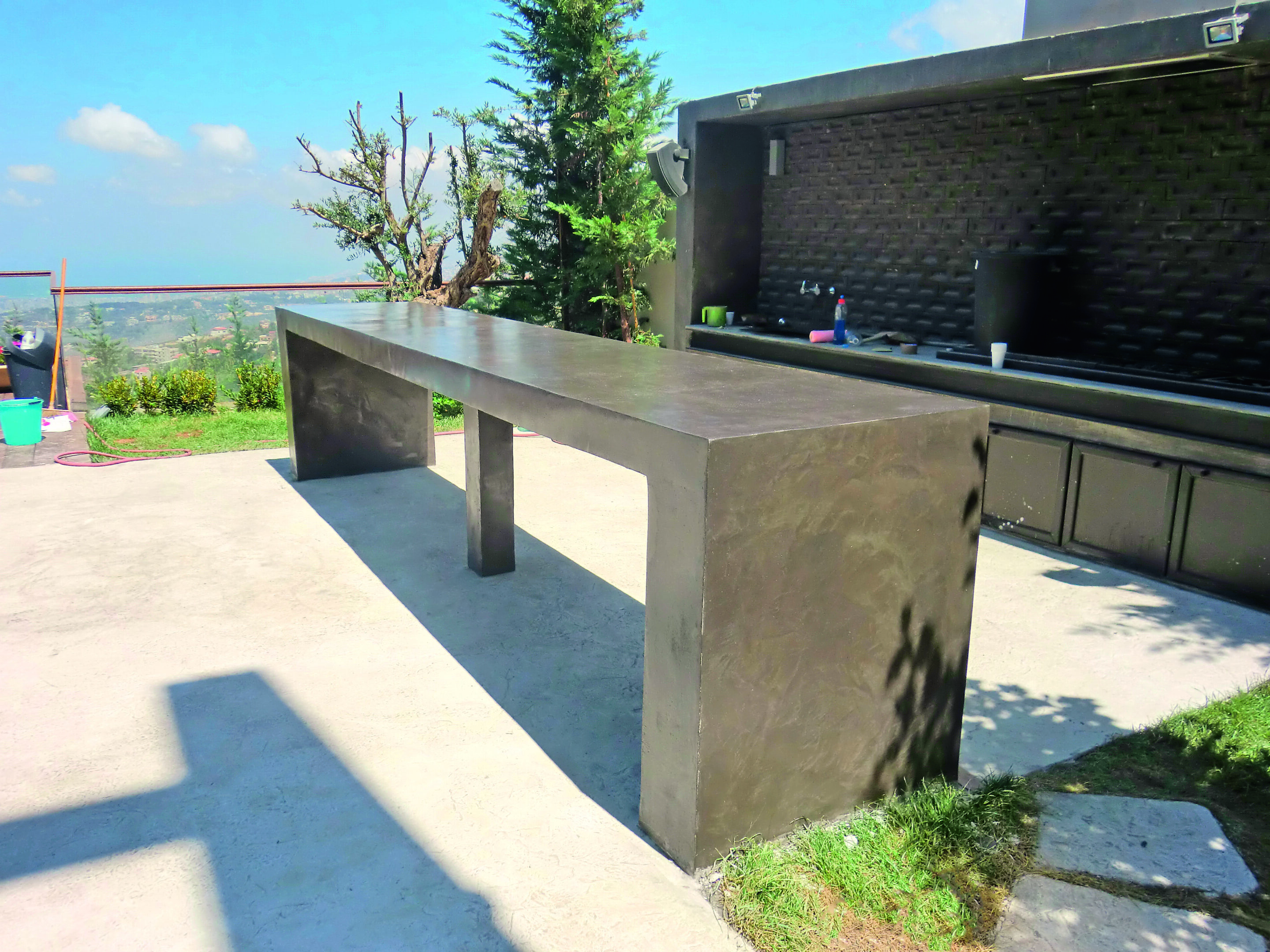Outdoor concrete table near barbecue area