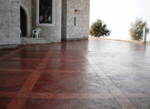 Red tiled patio by stone structure