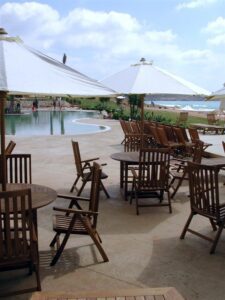 Poolside wooden chairs and umbrellas