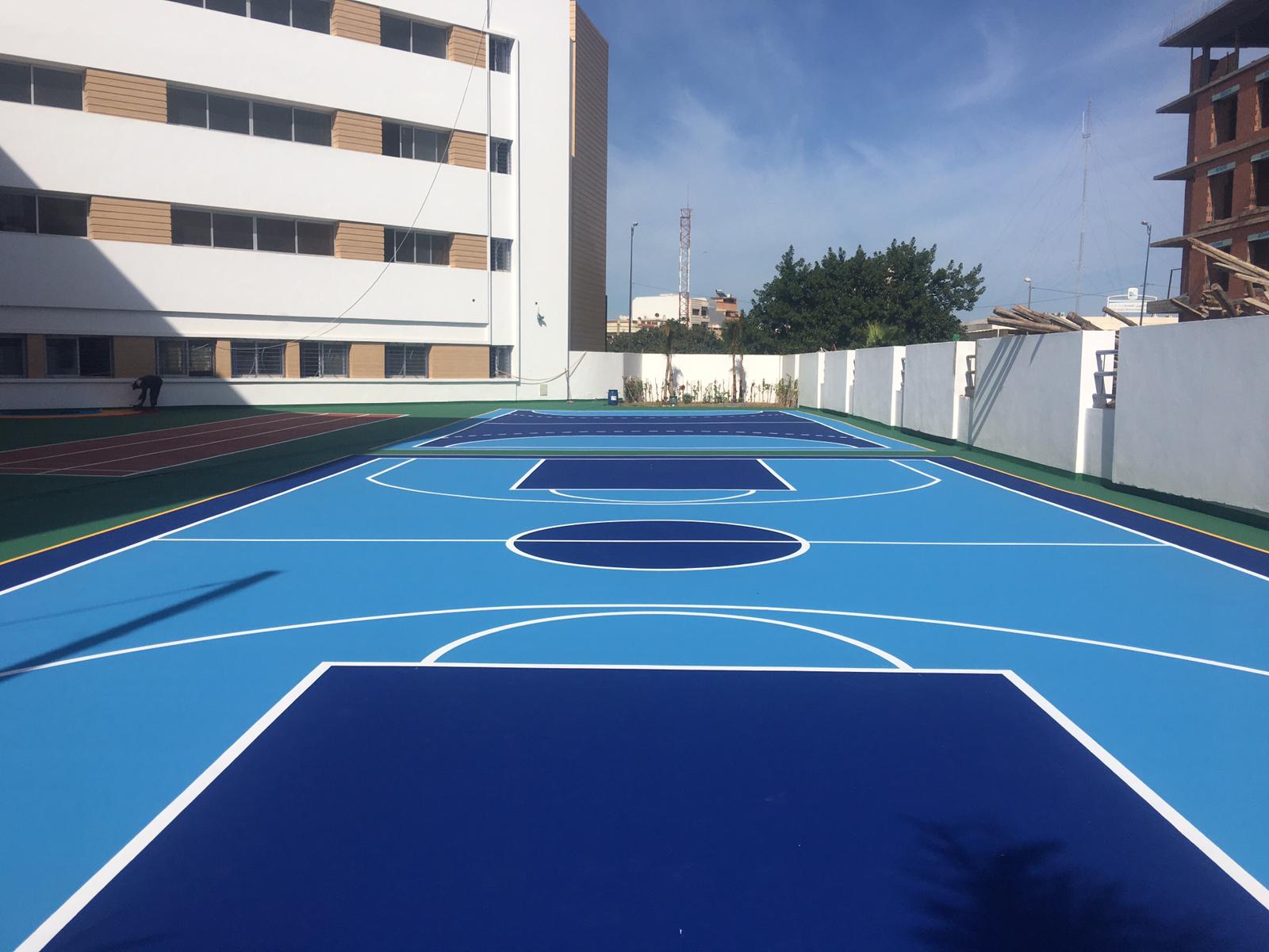 Blue outdoor sports court beside building