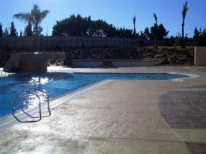Sunlit swimming pool and patio