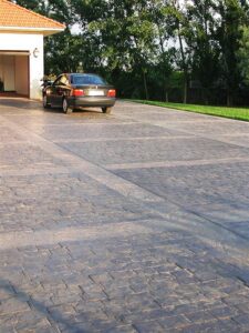 House garage with driveway and car