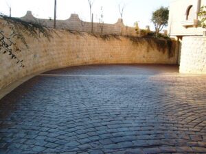 Stone-walled driveway with cobblestone pavement