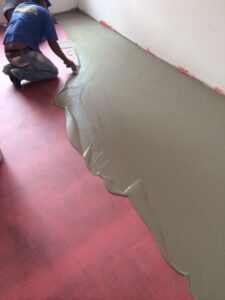 Flooring installation with leveling compound