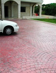 Arched entrance and red paved driveway