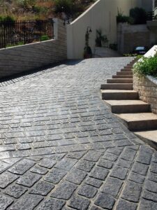 Sloped driveway leading to stairs