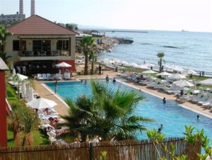 Seaside hotel pool area with umbrellas