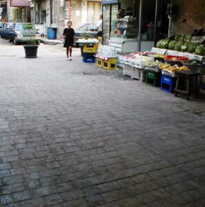 Cobblestone street with outdoor grocery display