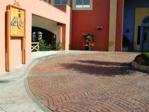 Curved brick driveway entrance with plants