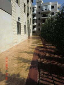 Apartment building with a tree-lined walkway