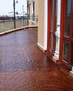 Rain-soaked brick walkway by building