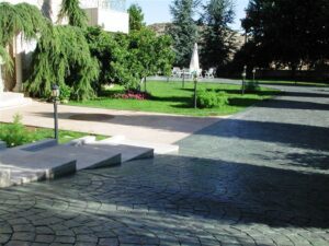 Garden with paved walkway and green lawn.