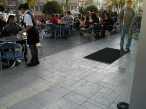 Waitress serving customers outside a cafe