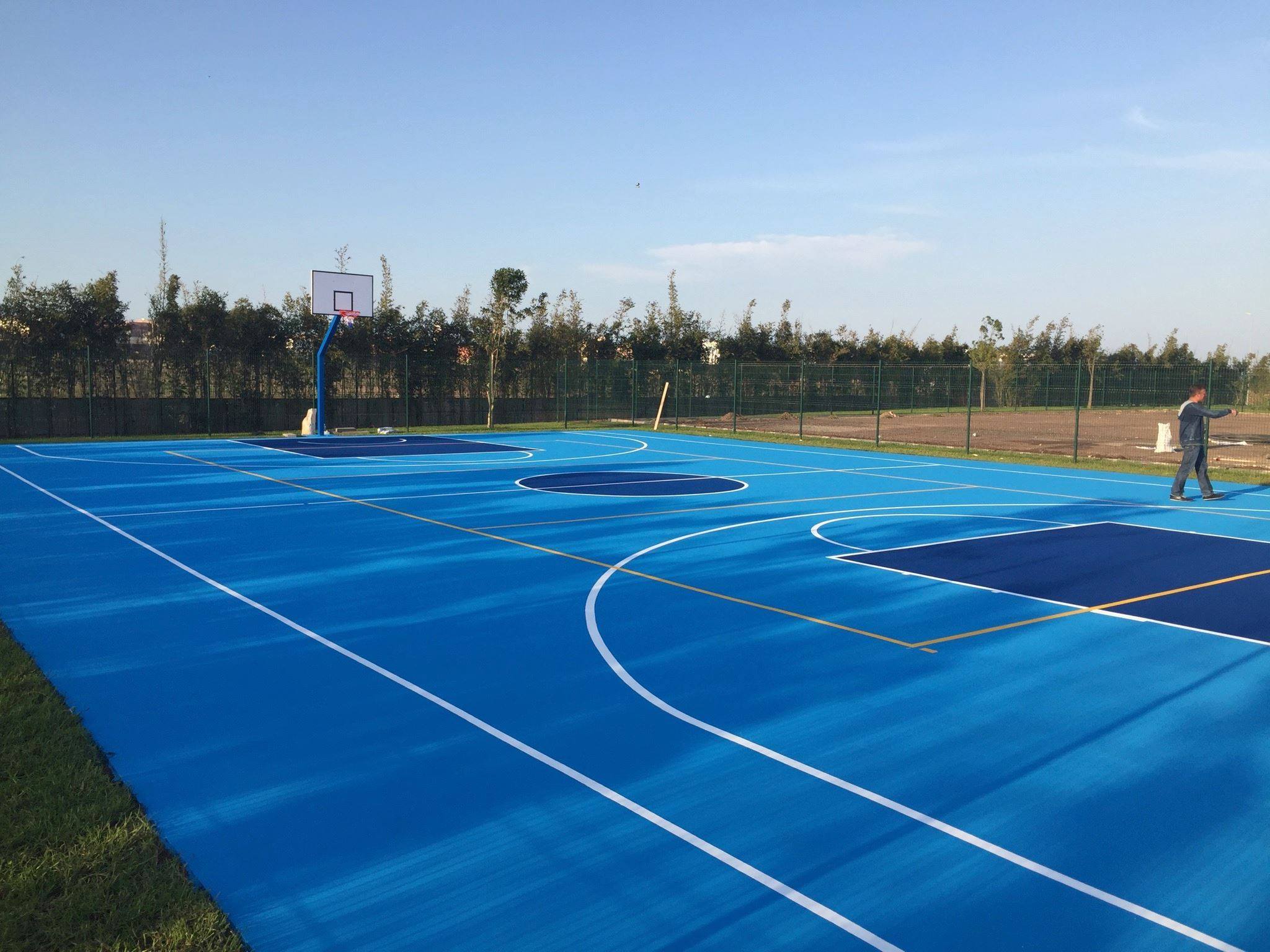 Sunny day on a blue basketball court