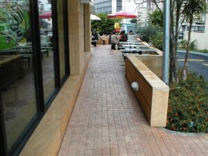 People dining outside near restaurant window