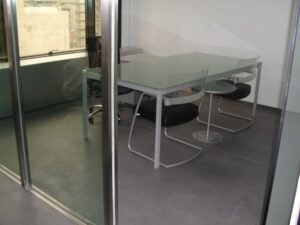 Minimalist conference room with black chairs.