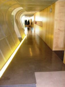 Long hallway featuring industrial style decor