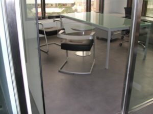 Bright office interior through glass door