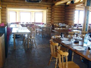 Rustic wooden restaurant interior with tables set