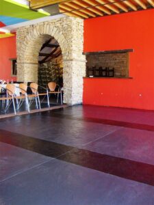 Stone archway in vibrant red room
