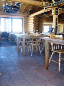 Rustic wooden dining area with log walls.
