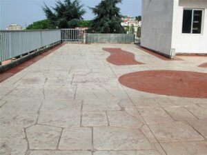 Large tiled terrace with railing and sky
