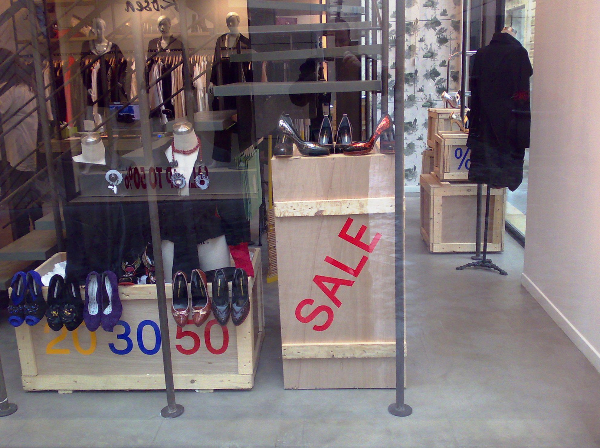 Storefront with sale signs and shoes