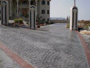 Cobblestone driveway leading to large house