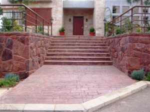 Red stone stairs with metal railings
