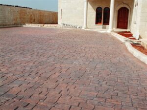 Stone-paved driveway leading to elegant entrance
