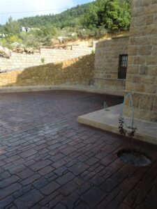 Courtyard beside stone building and wall