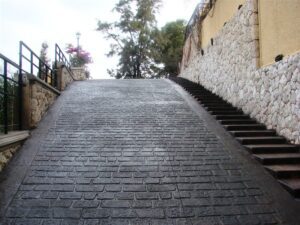 Steep cobblestone path with side stairs