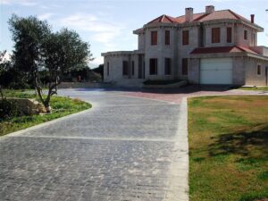 Elegant home with stone exterior and trees