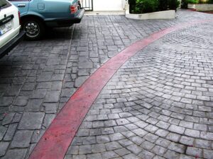 Driveway with parked cars and red stripe
