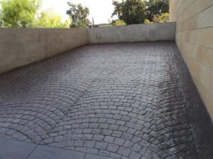 Cobblestone driveway with concrete walls