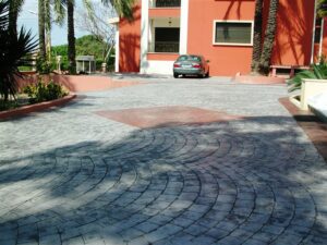 Curved stone driveway with parked car