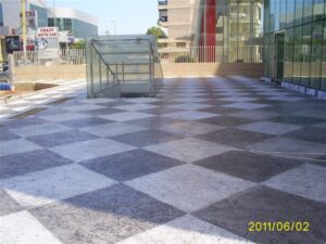 Checkered outdoor plaza with glass entrance