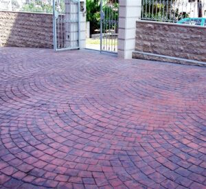 Red brick driveway pattern near entrance gate