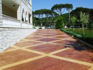 Elegant patterned driveway beside stone building