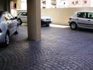Cars parked on cobblestone driveway