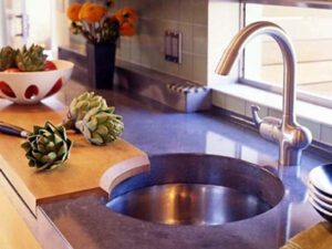 Artichokes on cutting board near sink