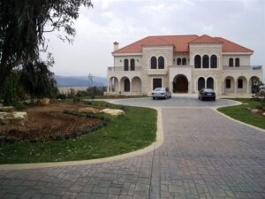 Grand estate with two parked cars