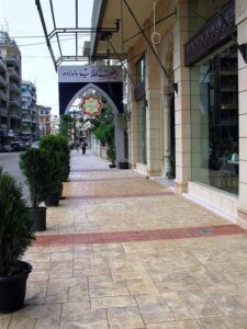 Empty sidewalk with decorative arch
