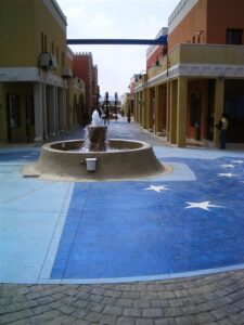 Outdoor fountain between colourful buildings