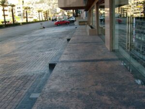 Modern sidewalk beside a glass building