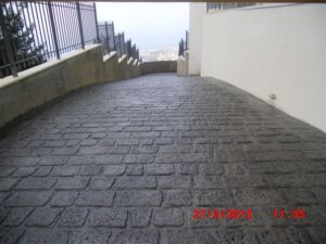 Stone-paved sloping pathway with city view