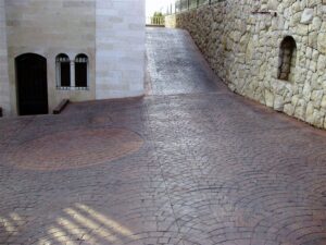 Stone building beside brick driveway