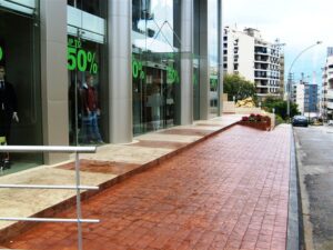 Glass storefront with green sale signs