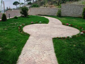 Curved path with green grass and flowers